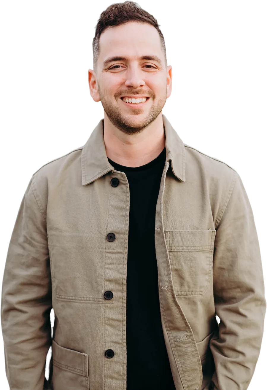 Joey Sarlo smiling in a tan jacket